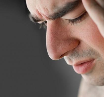 A young man that has an intense headache.