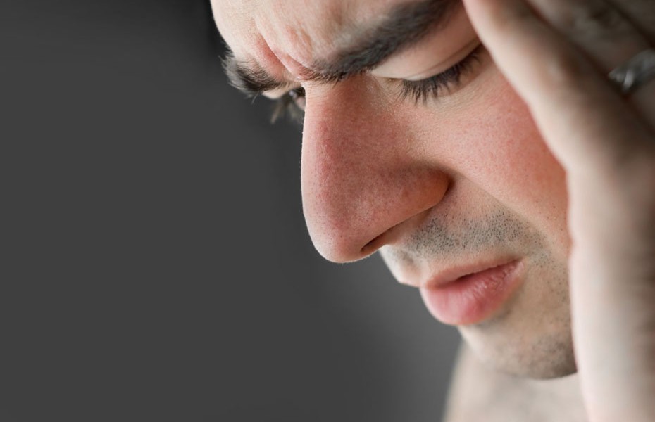 A young man that has an intense headache.