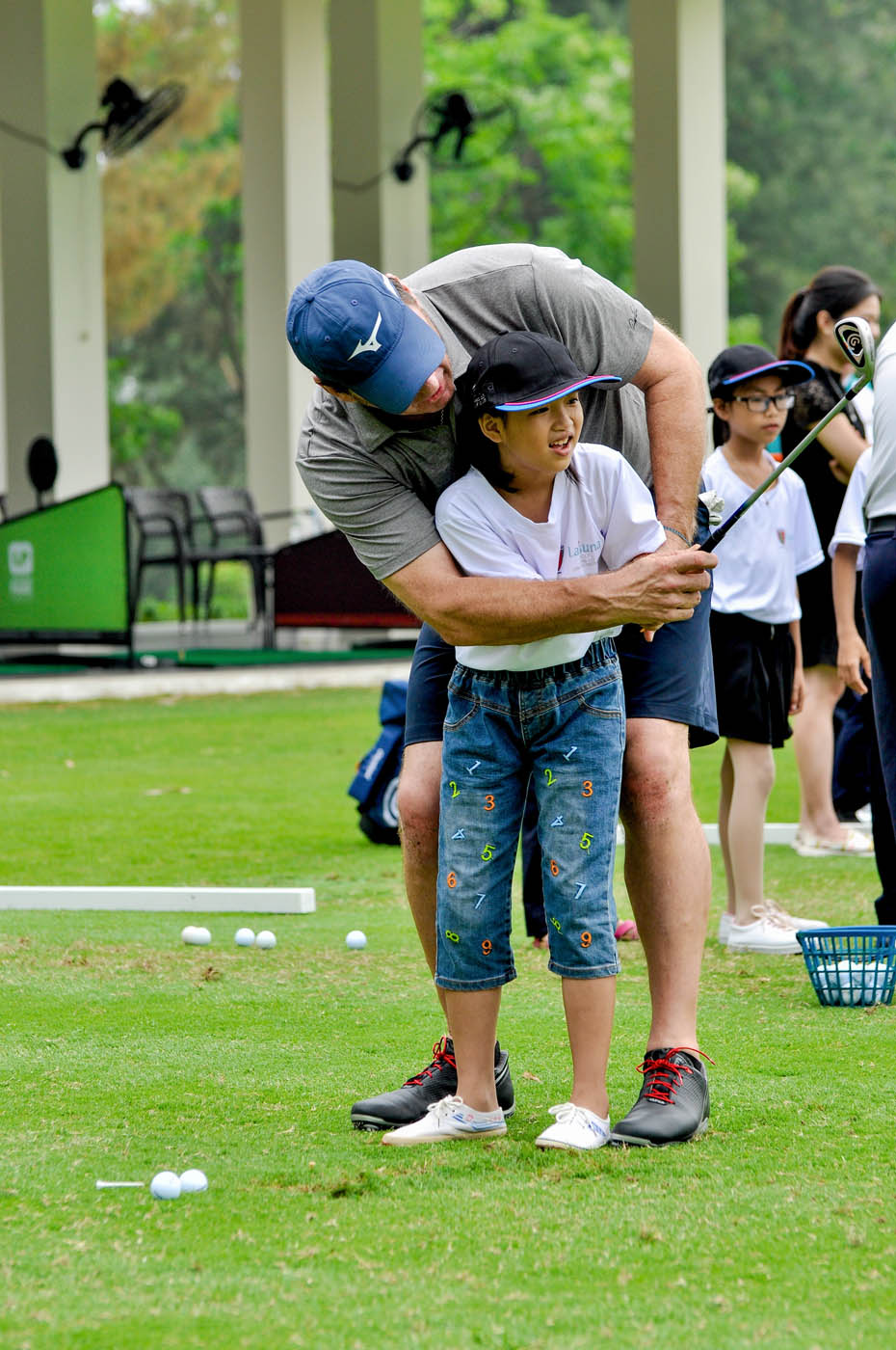 Sir Nick Faldo with a local student for Swing For Fun activity_March 14